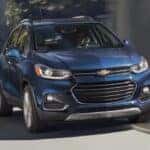 A blue 2020 Chevy Trax is shown driving after viewing used SUVs for sale in Albany.