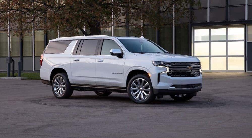 A white 2021 Chevy Suburban is shown parked near a building.
