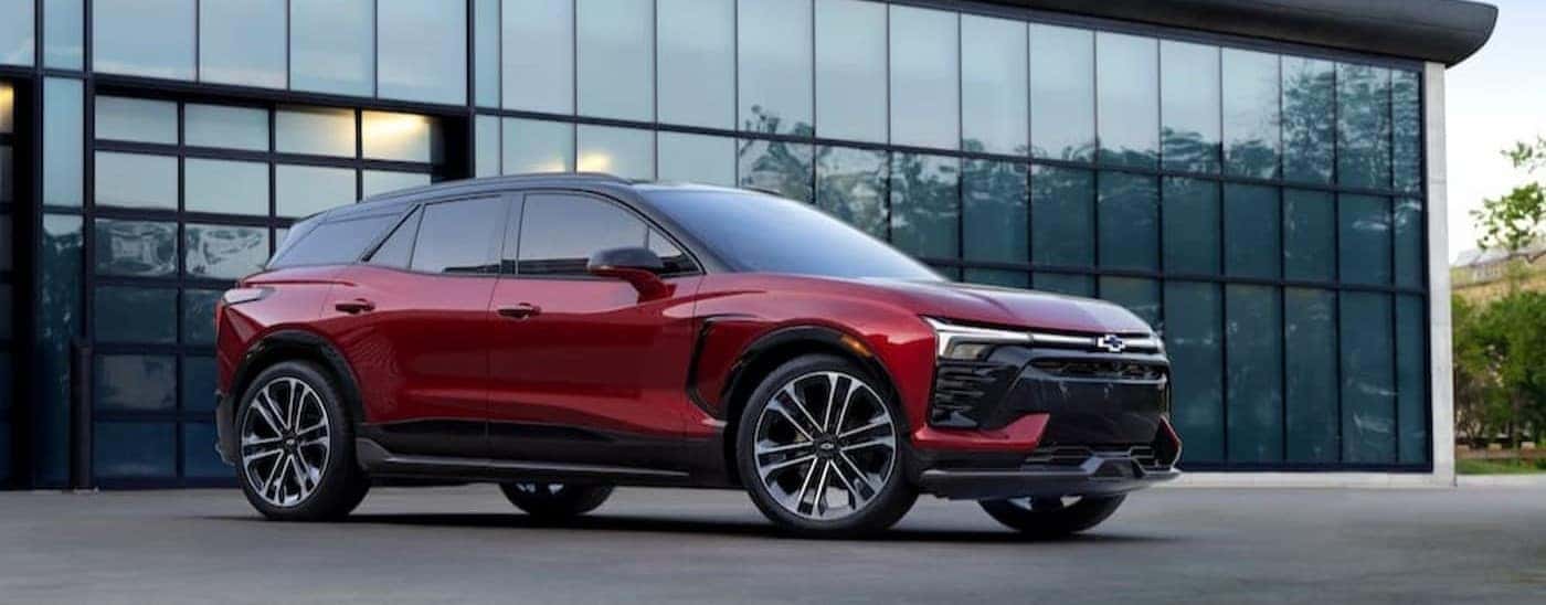 A red 2024 Chevy Blazer EV is shown parked near a building.