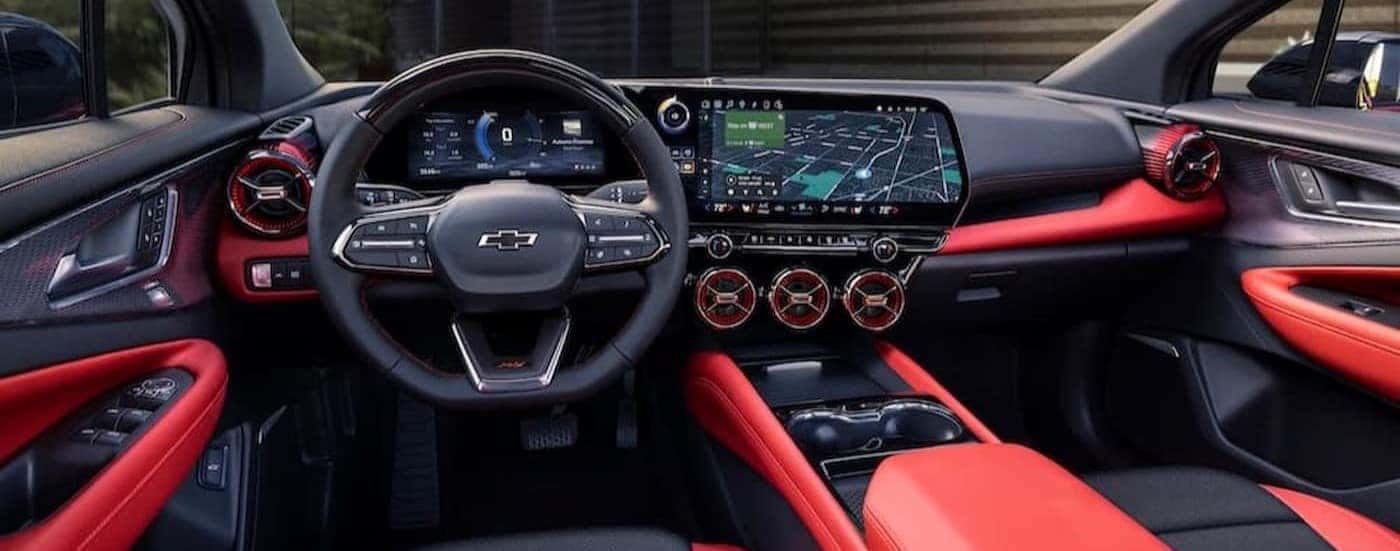 The black and red interior and dash of a 2024 Chevy Blazer EV is shown.
