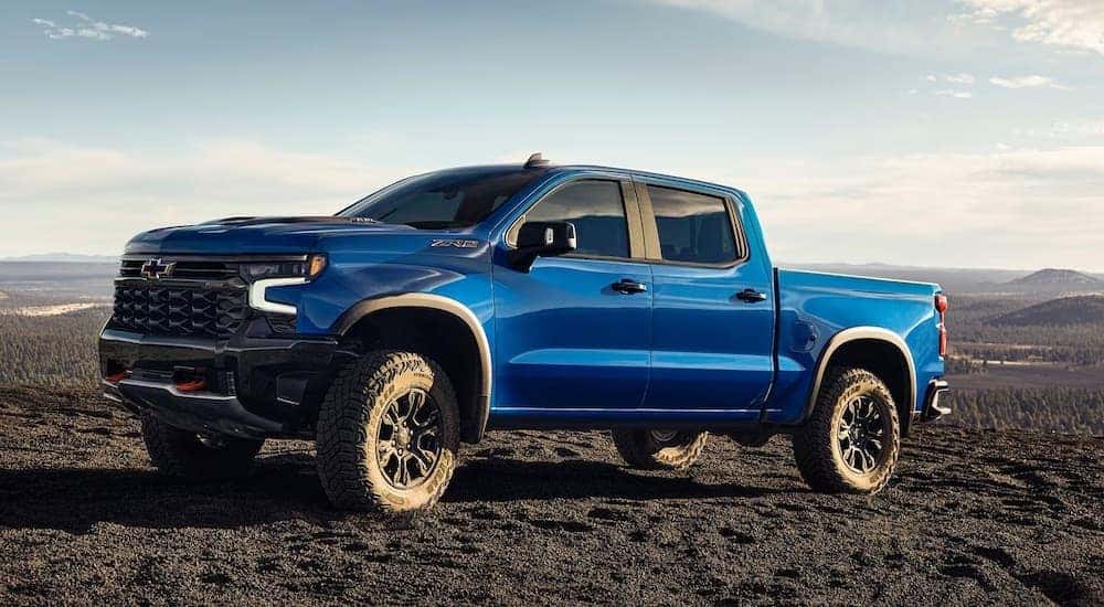A white 2024 Chevy Silverado 1500 ZR2 is shown parked off-road.