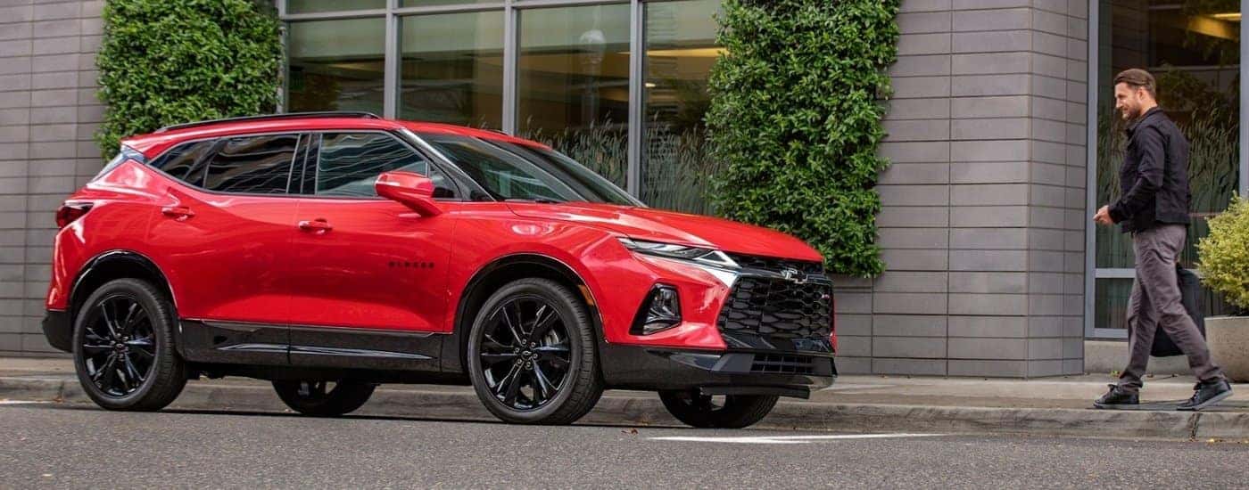 A red 2020 Chevy Blazer RS parked next to a building.