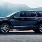 A black 2021 Chevy Traverse High Country is shown driving from a dealer with used SUVs for sale near Colonie.