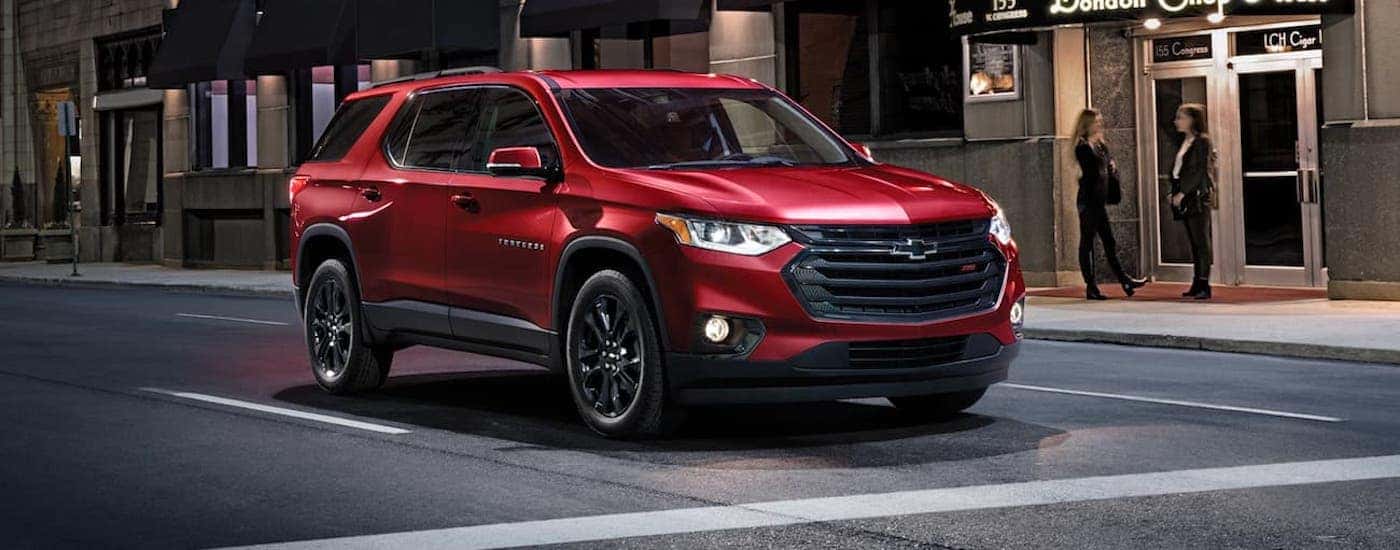 A red 2020 Chevy Traverse RS is shown driving.