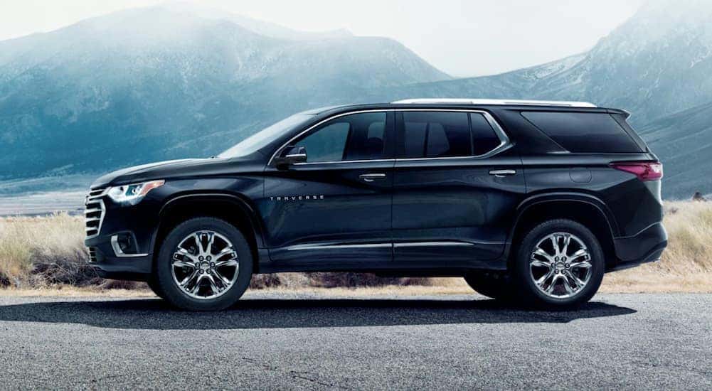 A black 2021 Chevy Traverse is shown parked at a side angle.