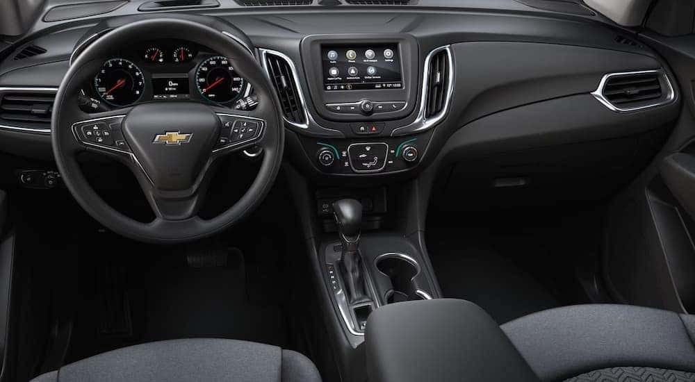 The black cloth interior of a 2024 Chevy Equinox LS.