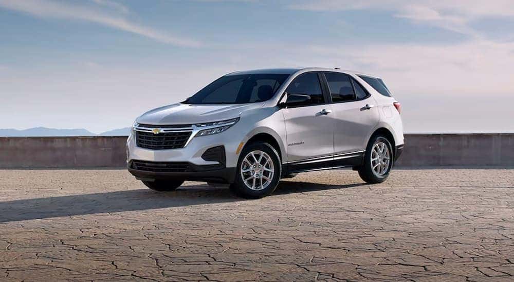 A white 2024 Chevy Equinox LS parked under an open sky.