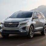 A silver 2024 Chevy Equinox is shown driving after a 2024 Chevy Equinox vs 2024 Honda CR-V comparison.
