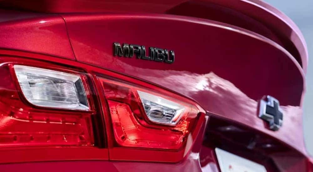 A close-up of the taillight on a red 2024 Chevy Malibu is shown.
