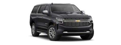 A black 2024 Chevy Suburban Premier is shown angled right.