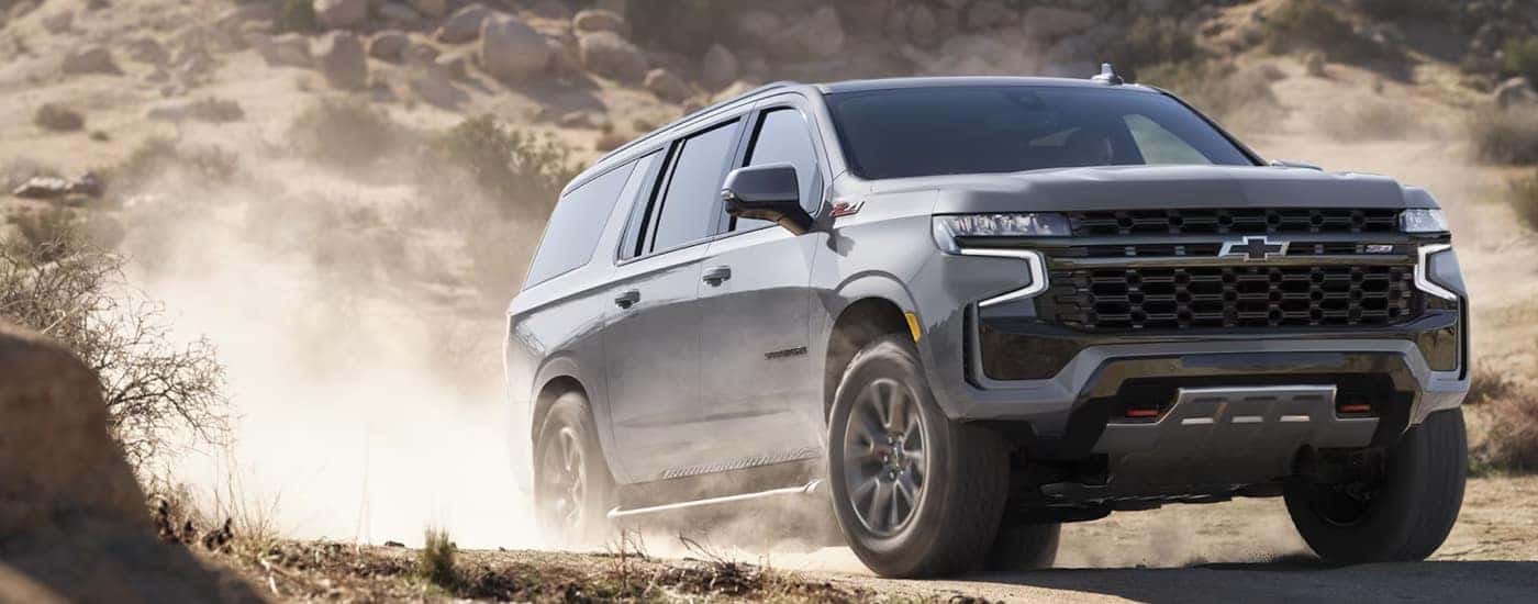A grey 2024 Chevy Subruban Z71 kicking up dust while off-roading.