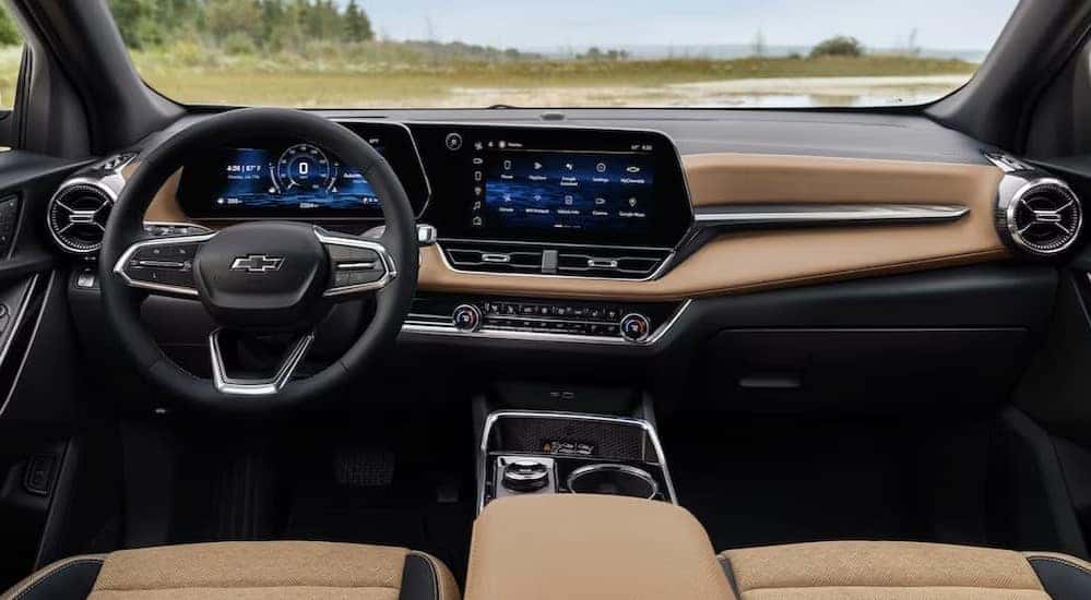 The black and brown interior and dash in a 2025 Chevy Equinox is shown.