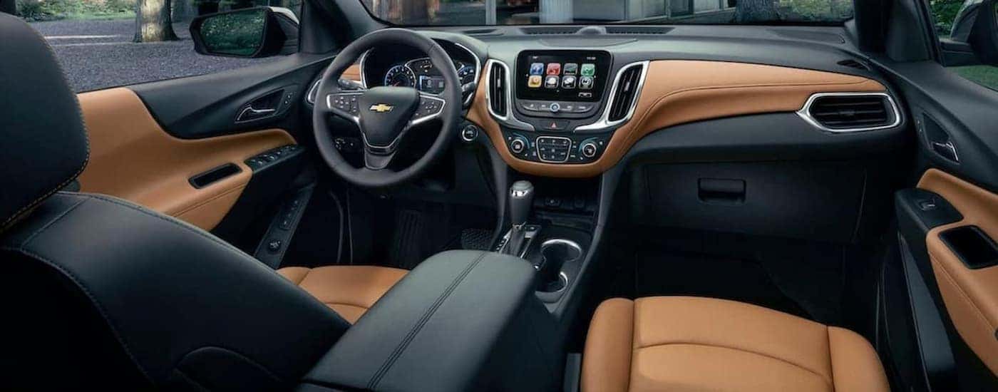 The black and brown leather interior of a 2020 used Chevy Equinox for sale.