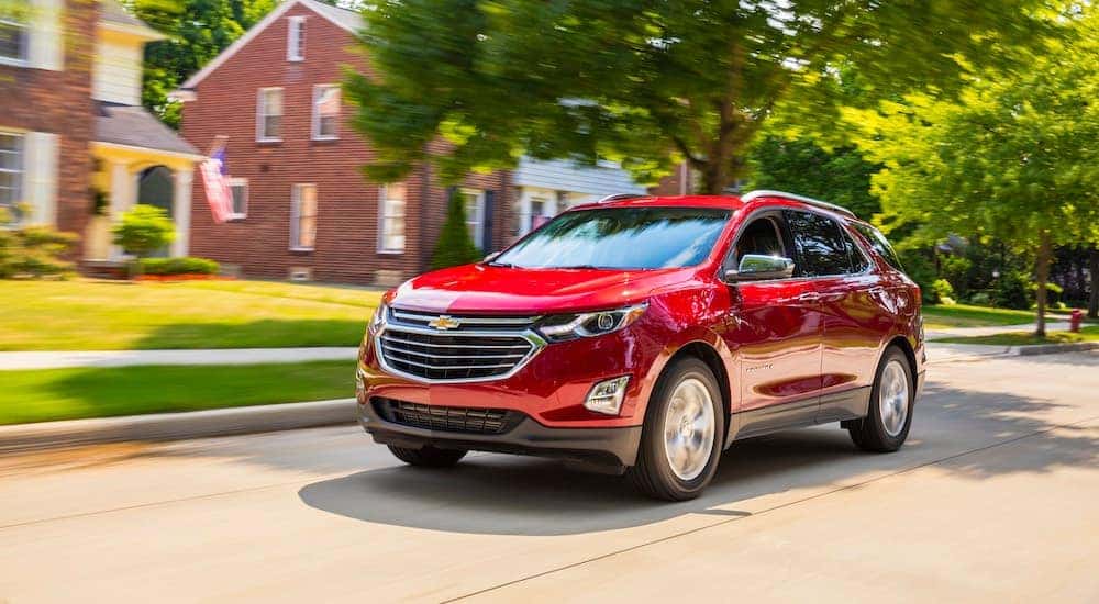 A red 2018 Chevy Equinox is shown driving.