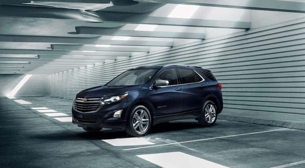 A dark blue 2021 Chevy Equinox is shown parked in a parking garage.