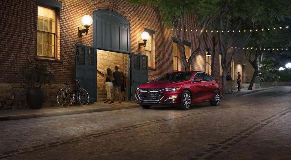 A red 2024 Chevy Malibu RS is shown from the front at an angle.