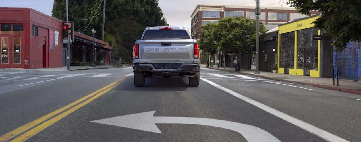 A silver 2023 Chevy Colorado Z71 is shown from the rear.
