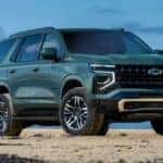 A green 2025 Chevy Tahoe Z71 is shown parked off-road.