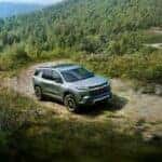 A grey 2024 Chevy Traverse Z71 driving on a mountain trail.