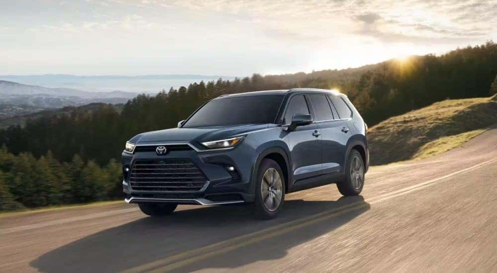 A grey 2024 Toyota Grand Highlander driving.