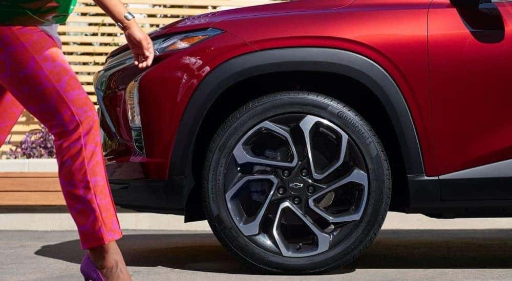 A close-up on a wheel on a red 2024 Chevy Trax RS.