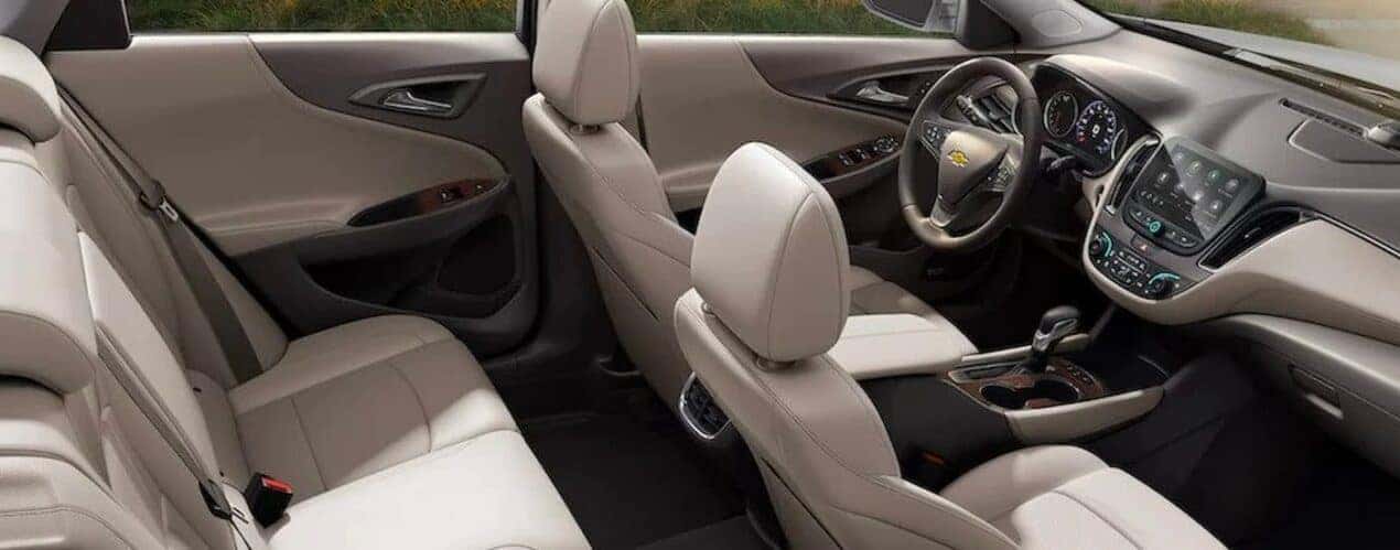 The white and gray interior and dash in a 2024 Chevy Malibu is shown.