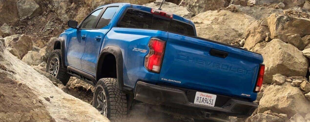 A blue 2024 Chevy Colorado ZR2 is shown off-roading.