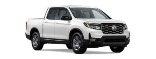 A white 2024 Honda Ridgeline TrailSport is angled right.