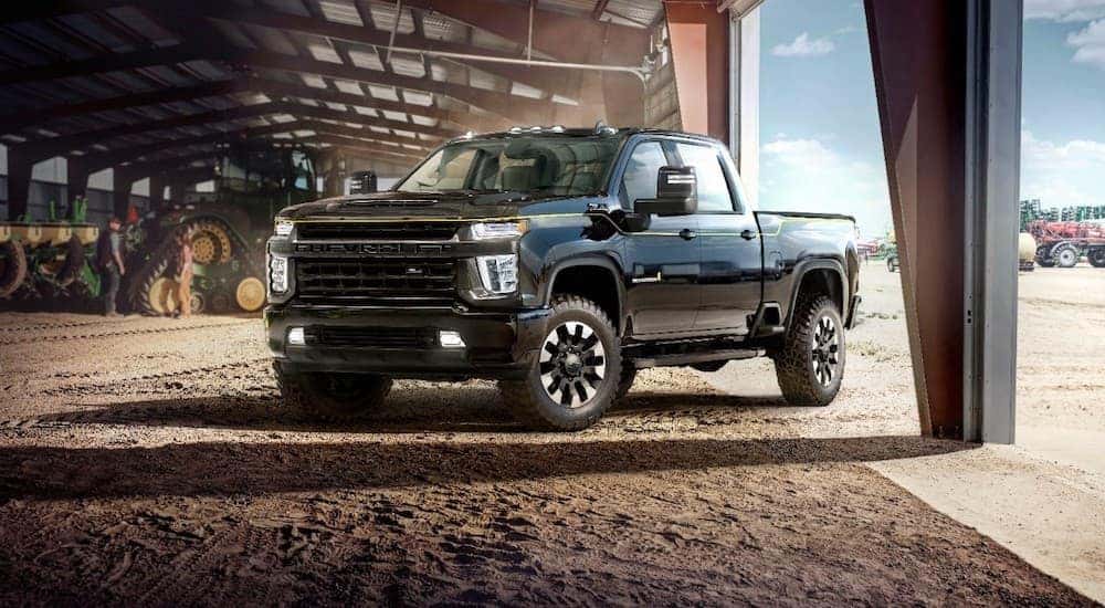 A black 2021 Chevy Silverado 2500 Carhartt Edition is shown parked in a barn.