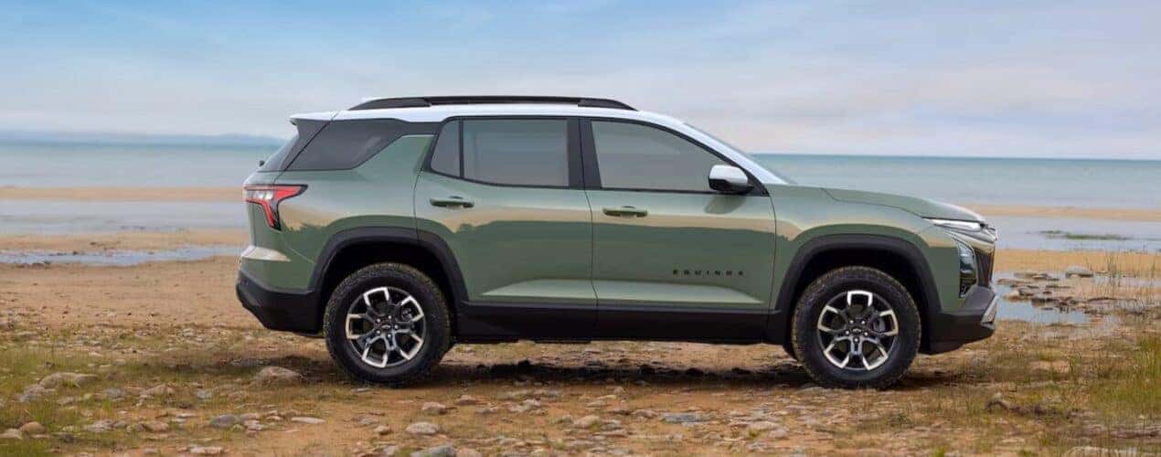 A green 2025 Chevy Equinox ACTIV is shown parked on a beach.