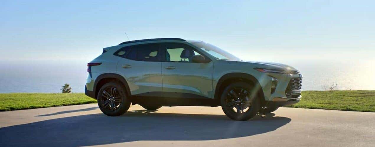 A green 2025 Chevy Trax ACTIV is shown parked on a sunny day.