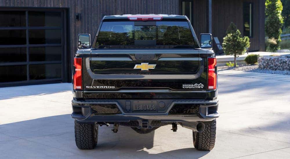 A black 2025 Chevy Silverado 2500 HD High Country is shown from the rear.