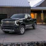 A black 2025 Chevy Silverado 2500 HD High Country is shown from the front at an angle.