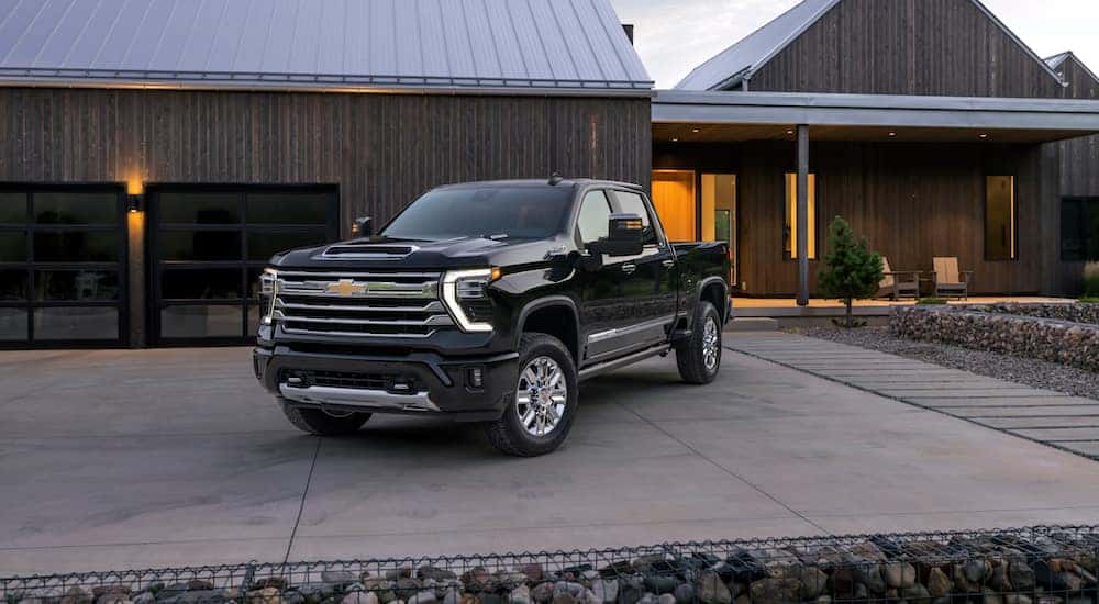 A black 2025 Chevy Silverado 2500 HD High Country is shown from the front at an angle.