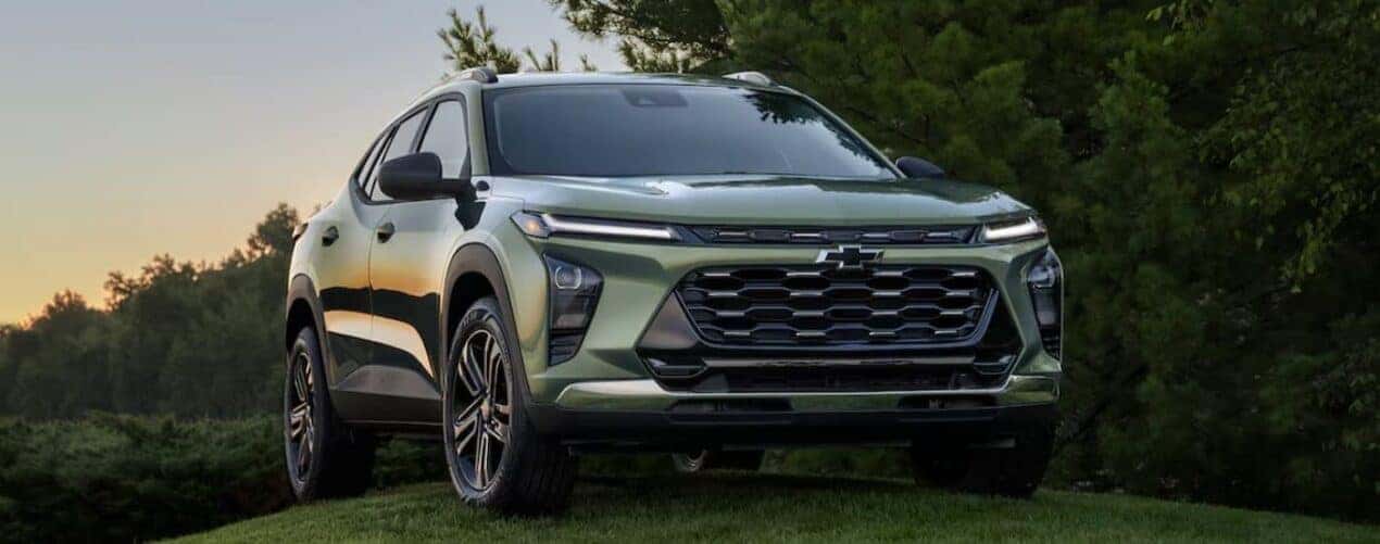 A green 2025 Chevy Trax ACTIV is shown parked on grass.