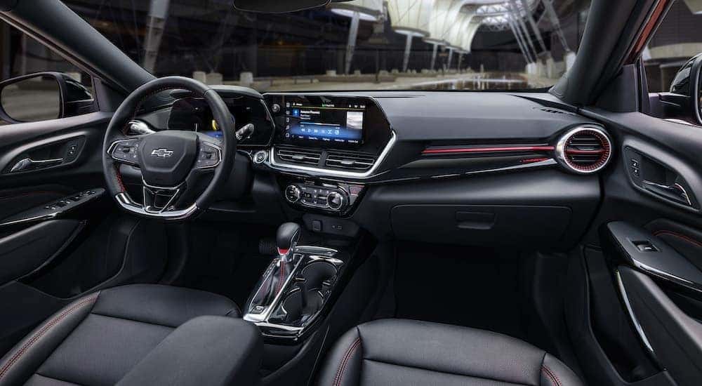 A black 2025 Chevy Trax RS is shown from the passenger seat.