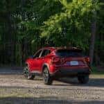 A red 2025 Chevy Trax RS is shown from the rear at an angle.