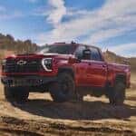 A red 2024 Chevy Silverado 2500 HD ZR2 Bison is shown from the side.