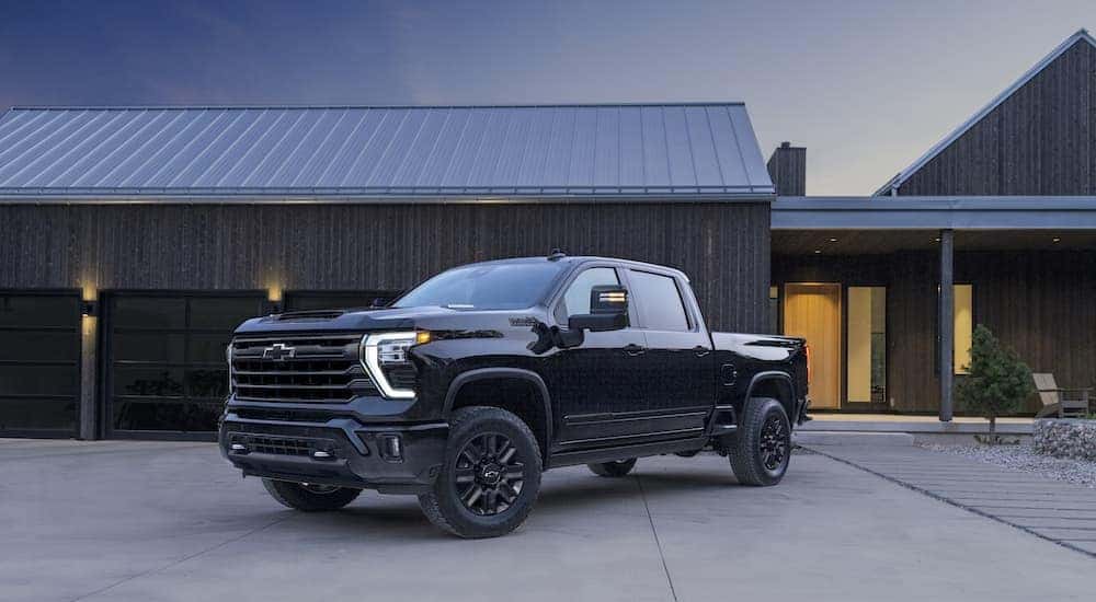 A black 2024 Chevy Silverado 2500 HD High Country Midnight Edition is shown from the front at an angle.