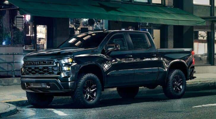 A black 2025 Chevy Silverado 1500 Z71 Trailboss is shown from the side.