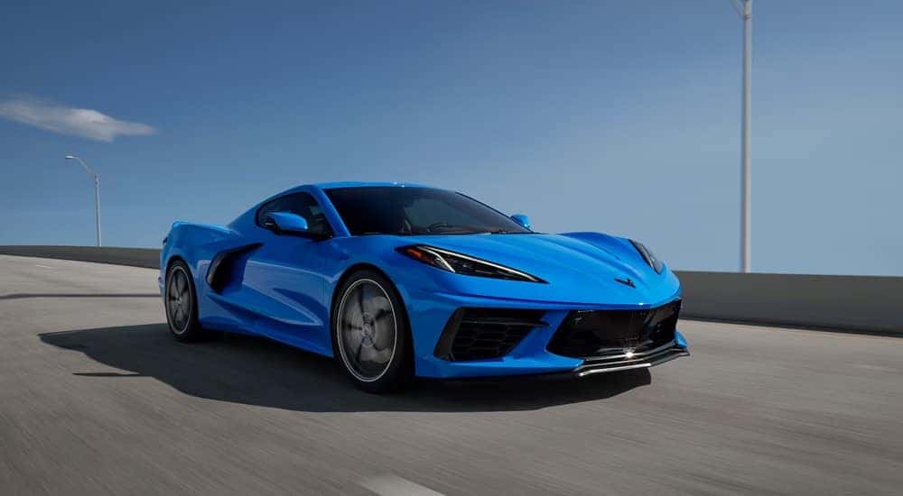 A blue 2021 Chevy Corvette Stingray 3LT with Z51 Performance Package driving over a bridge.