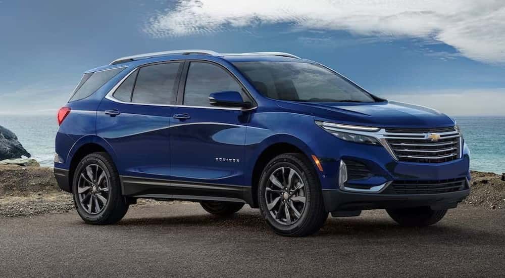 A blue 2023 Chevy Equinox LT is shown parked after viewing a used Chevy for sale near Colonie.