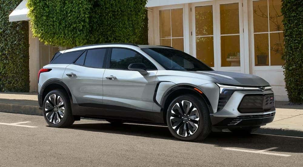 A silver 2025 Chevy Blazer EV RS parked on a city street.