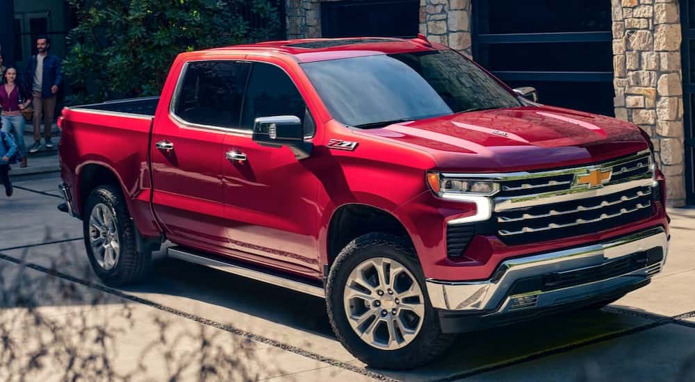 A red 2025 Chevy Silverado 1500 Z71 is shown parked on a driveway.