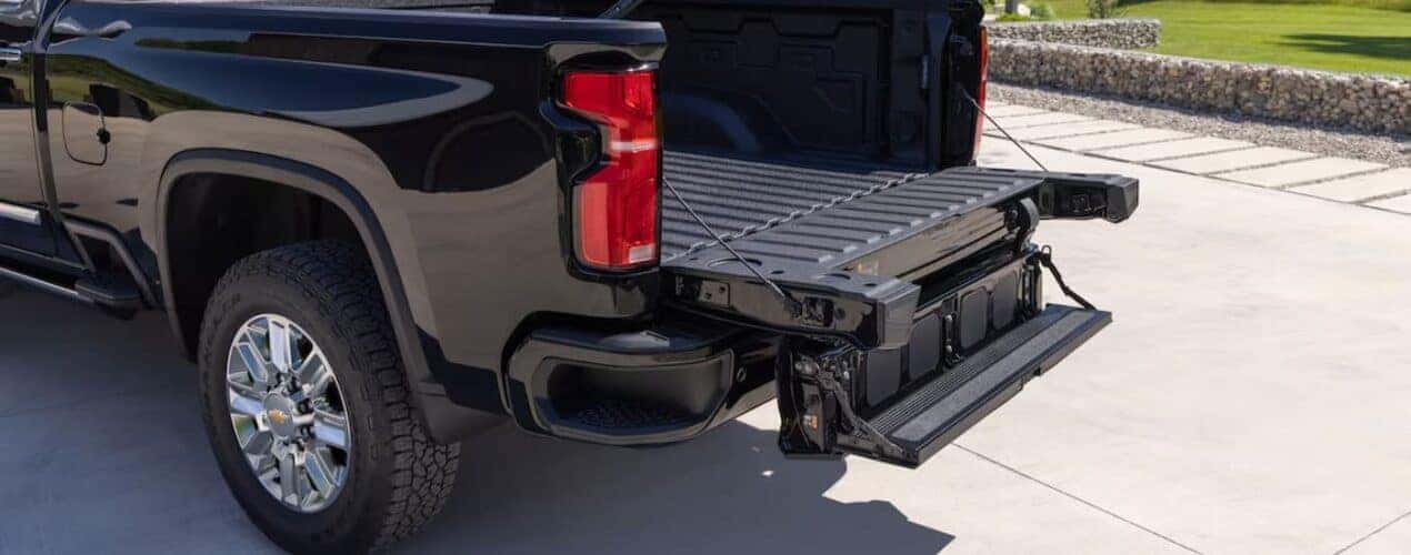 The multi-flex tailgate is shown open on a 2025 Chevy Silverado 2500 High Country.