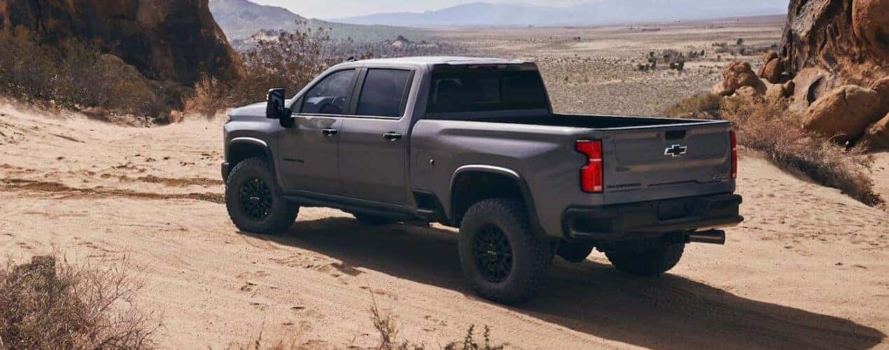 A gray 2025 Chevy Silverado 2500 ZR2 is shown parked off-road.