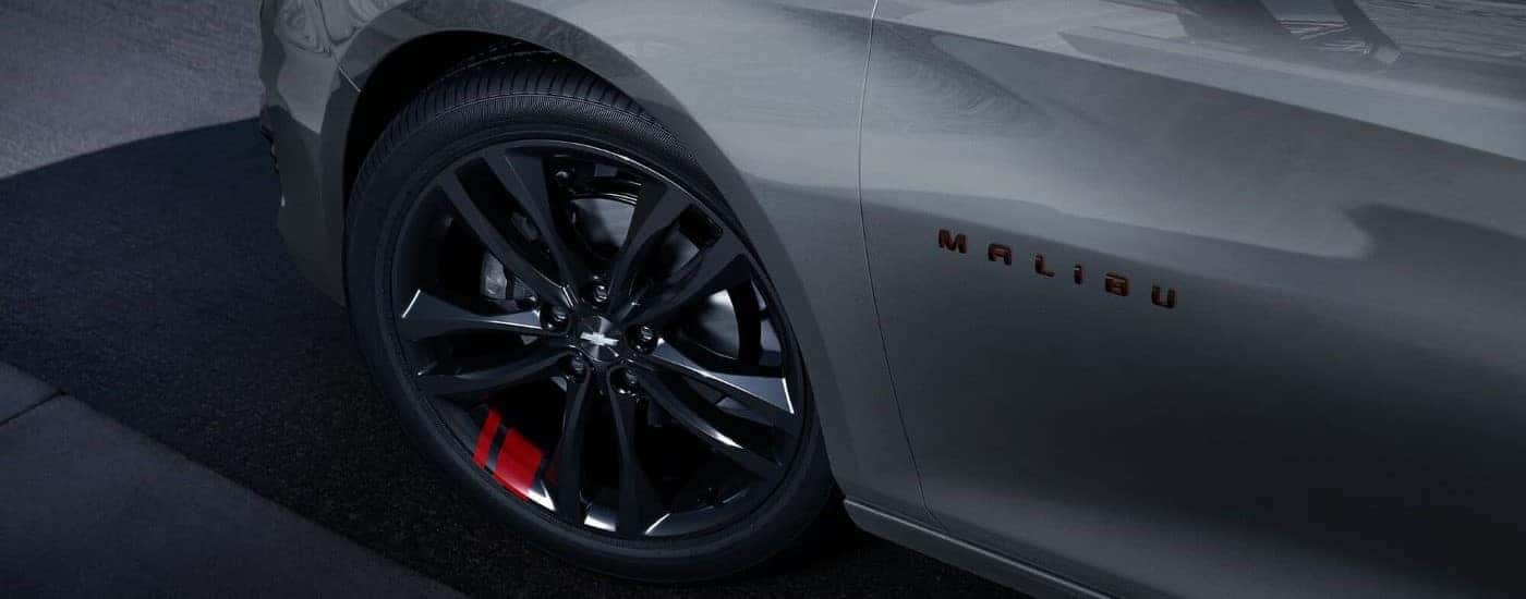 Close-up on the wheel of a grey 2023 Chevy Malibu Redline.