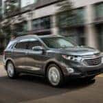 A 2019 Chevy Equinox is shown driving after viewing a used Chevy Equinox for sale in Colonie.