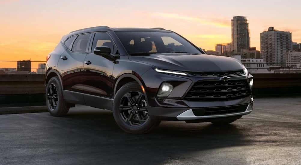 A black 2025 Chevy Blazer Midnight Edition is shown parked near a city.
