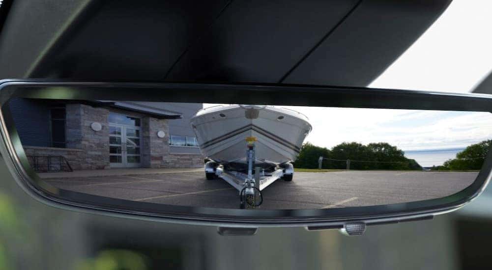 A close-up of the rearview mirror is shown in a 2025 Chevy Silverado 2500 for sale near Colonie.